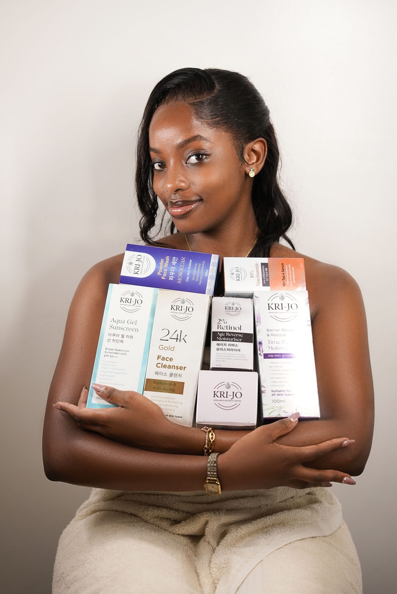 KRI-JO founder holding the Korean skincare product range
